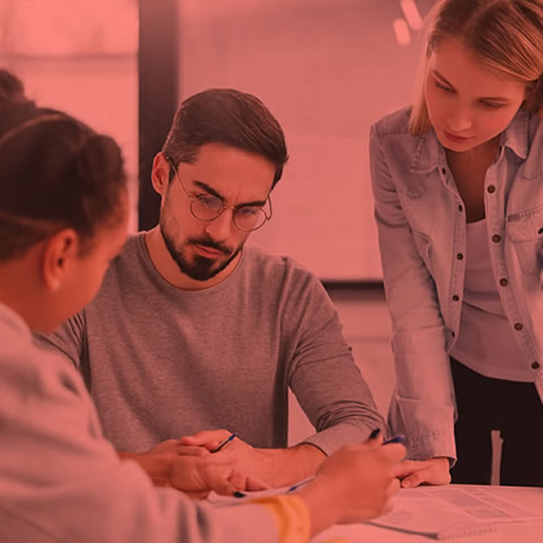 Three office workers collaborating